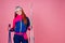 Portrait of sexy smiling redhaired ginger woman in warm clothes professional skier in studio pink background.knitted