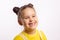 Portrait of shining little kid showing missing front baby tooth and smiling looking away in yellow t-shirt on white