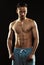 Portrait of a shirtless confident young athletic man standing ag