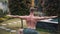 Portrait of shirtless man with muscular body doing yoga exercises in garden