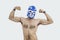 Portrait of a shirtless man in wrestling mask flexing muscles over gray background