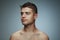 Portrait of shirtless young man isolated on grey studio background