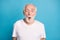 Portrait of shocked aged man open mouth look camera cant believe isolated on pastel blue color background