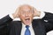 Portrait of shocked elderly businessman against white background