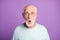 Portrait of shocked old man wear casual cloth eyeglasses open mouth isolated on purple color background