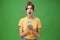 Portrait of shocked speechless and impressed beautiful white girl with combed hair in yellow t-shirt holding smartphone