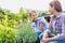 Portrait of shop owner showing flowers to woman buyer