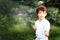 Portrait of short haired 7 years old girl in white kimono making karate kata training outdoors. Martial arts. Sport and activity