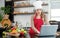 Portrait shot of Asian young cute female chef wears white tall cook hat and apron smiling posing look at camera learning cooking