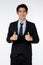 Portrait shot of Asian young happy confident white collar businessman in black stylish modern formal suit standing smiling look at