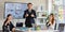 Portrait shot group of millennial professional successful businessman and businesswomen in formal suit standing sitting showing