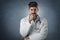 Portrait shot of thinking male doctor standing at isolated background