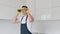 Portrait shot of the young adult man putting on protective glasses before screwing new handle for cabinet on the kitchen.