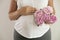 Portrait shot of young beautiful woman on third trimester of pregnancy. Close up of pregnant female with arms on her round belly.