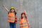 Portrait of sibling girl with a construction hat