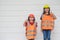 Portrait of sibling girl with a construction hat