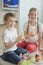 Portrait of siblings celebrating birthday with cup cakes