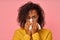 Portrait of sick African American woman sneezes in white tissue, suffers from rhinitis and running nose, has allergy on