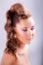 portrait sideview of blonde girl in elegant whimsical coiffure