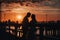 Portrait silhouette of a beautiful newlywed couple. A loving man hugs a girl at sunset, against the background of the