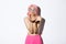 Portrait of silly beautiful caucasian girl with bright makeup, dressed for party in glam pink wig, blowing air kiss at