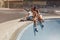 Portrait Of Skater Girls At Skatepark. Female Teenagers In Casual Outfit Sitting On Concrete Ramp.