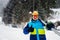 Portrait of a skier in a protective glasses with skis on his shoulder