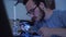 Portrait of skill young bearded man in glasses working with a soldering iron at his working place. Concept of the