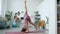 Portrait of skilled young lady standing upside down enjoying yoga practice at home