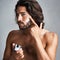 Portrait, skincare or cream with a shirtless man in studio on a gray background for his grooming routine. Beauty, facial