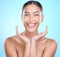 Portrait, skincare and woman with hands on face in studio for beauty, wellness and grooming on blue background. Facial