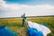 Portrait of skydiver in a jumpsuit with glasses on meadow