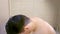 Portrait of sleepy young man sleeping standing in bathroom in early morning.