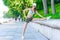 portrait of slender woman athlete who is warming up before jogging