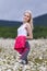 Portrait of slim girl in sportswear at chamomile field