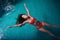 Portrait of slim young woman relaxing in swimming pool floating on back