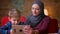 Portrait of small boy and his muslim mother in hijab watching into tablet together and discussing.