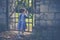 Portrait of a small four year old girl at a old iron gate in a park in autumn.