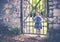 Portrait of a small four year old girl at a old iron gate in a park in autumn.