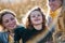 Portrait of small girl with mother and grandmother resting in autumn nature.