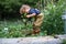 Portrait of small girl working in vegetable garden, sustainable lifestyle.