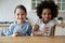 Portrait of small multiracial girls drink mineral water