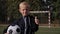 Portrait of a small seven-year-old boy on a soccer field with a soccer ball.