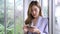 Portrait of smart confidence Asian female startup entrepreneur uses phone and Internet technology, SME online store social e-