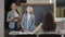 Portrait of smart cute Caucasian schoolgirl talking and smiling standing in classroom with teacher and classmate