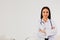 Portrait of a smart female doctor in the office against a white background.