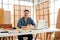 Portrait of a smile Asian male father sitting and working with a laptop on the table with the instrument of measure and working