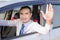 Portrait of smile asian man driving a car opem car window and sh