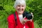 Portrait of smile, happy grandmother enjoy her hobby at sun day. modern granny is professional photographer