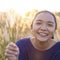 Portrait smile young girl at field gass